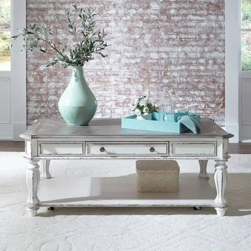 Rectangular Cocktail Table in Antique White with Weathered Top Turned Legs Casters and Bottom Shelf